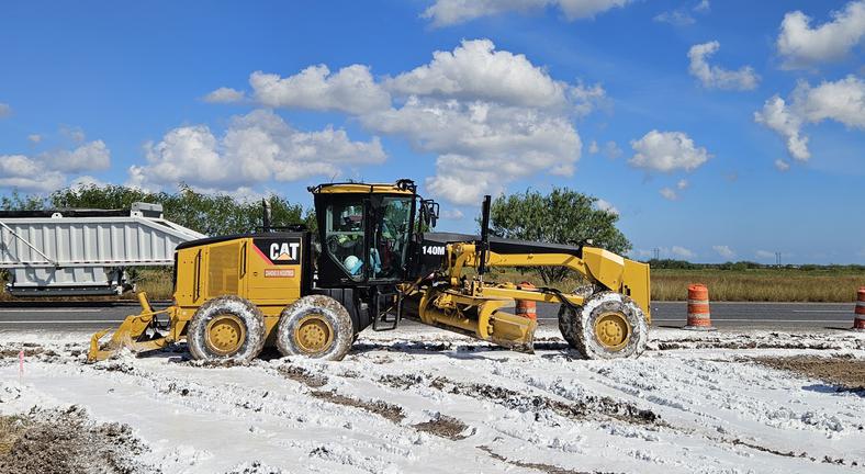 Diamond Eight CAT 140M motor grader — lime-treated base