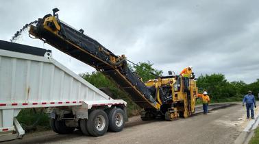 Diamond Eight road milling machine loading dump truck — South Texas